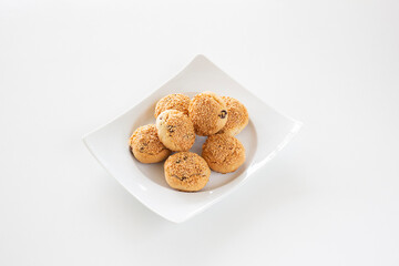 Delicious homemade sweet cookies with huzelnut on white plate.