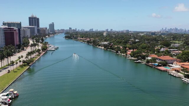 Aerial Miami Beach Waterway along Collins Avenue and Pine Tree Drive following a boat