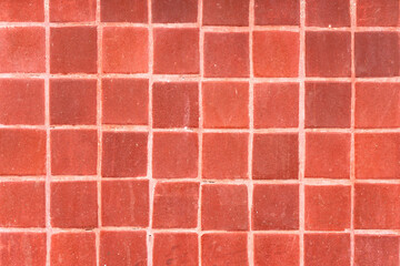 Close-up of red tiled wall. Texture wallpaper background.