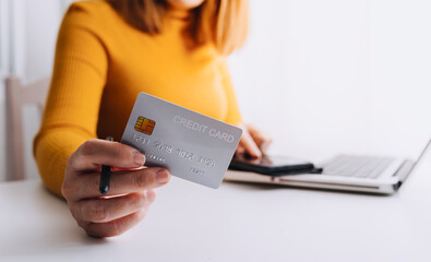 male hands holding a credit card and use mobile phone for Online payment online shopping