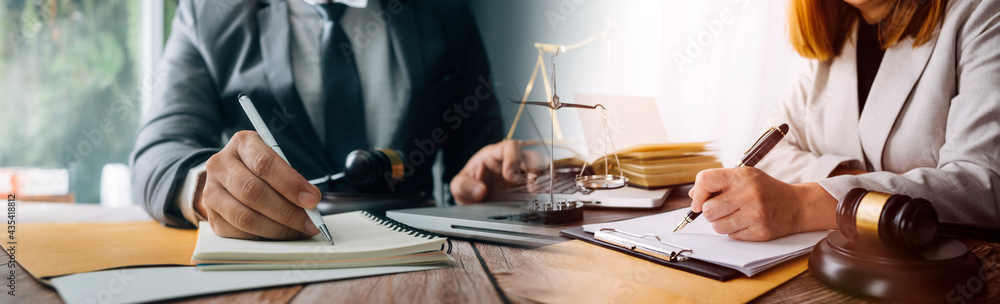 Wall mural justice and law concept.male judge in a courtroom with the gavel, working with, computer and docking