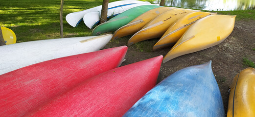 Canoes on the shore waiting for children in the summer camp