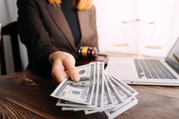 Justice and law concept.Male judge in a courtroom with the gavel, working with, computer and docking keyboard, eyeglasses, on table in morning light