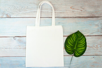 Tote bag canvas fabric cloth shopping sack mockup blank template on wooden background. Stock photo