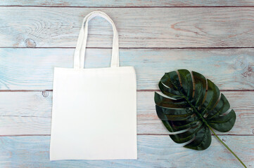 Tote bag canvas fabric cloth shopping sack mockup blank template on wooden background. Stock photo