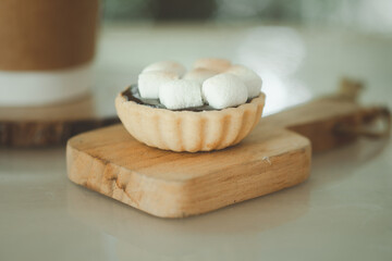 A small homemade tart on top with marshmallow