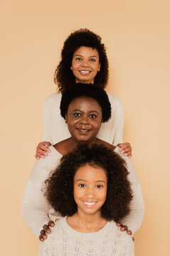 African American Family Of Grandmother, Mother And Daughter Standing Together Isolated On Beige
