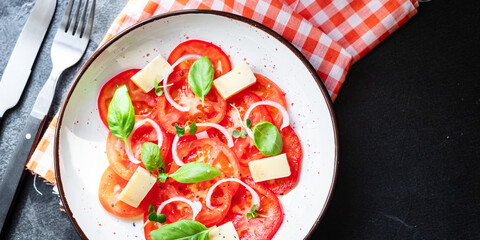 tomato salad veggie vegetable, cheese, onion diet vitamin on the table healthy food keto or paleo diet meal snack copy space food background rustic. top view vegan or vegetarian food