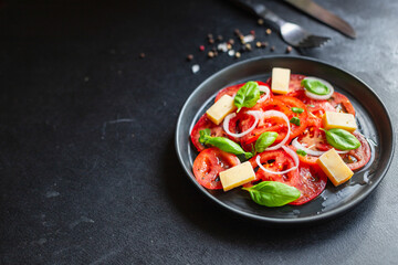 tomato salad veggie vegetable, cheese, onion diet vitamin on the table healthy food keto or paleo diet meal snack copy space food background rustic. top view vegan or vegetarian food