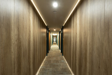 Carpeted corridor hallway interior with wooden walls
