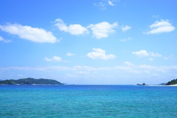 Obraz na płótnie Canvas Beautiful summer scenery of Zamami port pier with lighthouse in Okinawa, Japan - 日本 沖縄 座間味港 ピア 青い海 