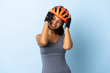 Young cyclist woman isolated on blue background laughing - obrazy, fototapety, plakaty