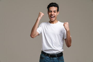 Smiling young brunette man in t-shirt standing