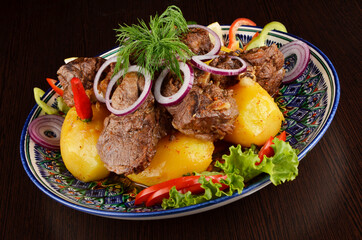 stew with potatoes, garnish with onion rings, pepper, lettuce and dill, Asian cuisine