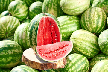 Red ripe watermelon sliced on a wooden board.