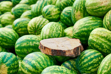 Watermelons are for sale with a blank sign on the board