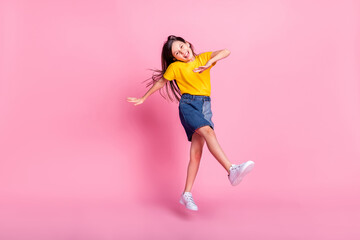 Full length body size view of attractive cheerful overjoyed girl jumping having fun fooling isolated over pink pastel color background