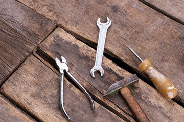 Used construction tools on old wooden boards.