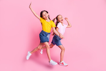 Full size profile photo of nice optimistic blond brown hair girls run wear t-shirt isolated on pink background