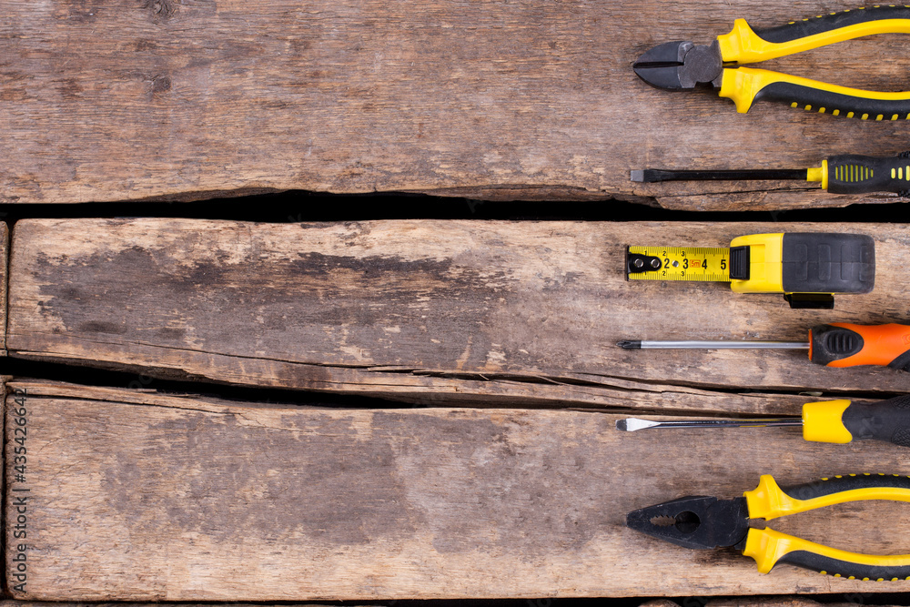 Wall mural Set of construction tools on cracked wooden boards.