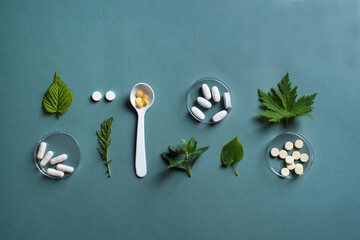 Herbal medicine, pills and green leaves