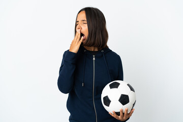 Young football player woman isolated on white background yawning and covering wide open mouth with hand