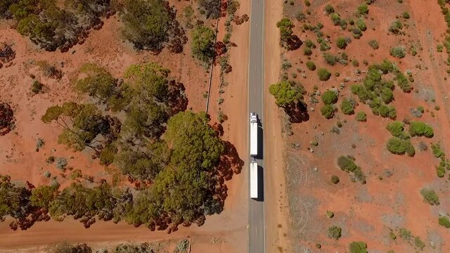 White Truck Driving on Eyre Highway at Australia Outback, Aerial Tilt Reveal