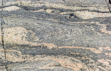 Close up a whimsical texture of smooth-cut bare rocks at the coast of the Barents sea in the vicinity of Grense Jakobselv, Finnmark, Norway