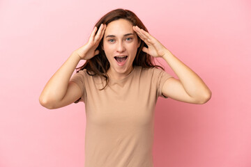 Young caucasian woman isolated on pink background with surprise expression