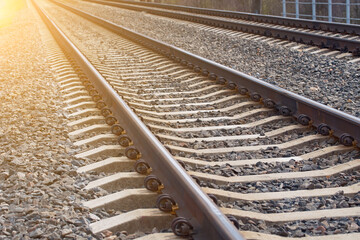 Railroad track leading to the sunny horizon, long straight train tracks. Transportation concept