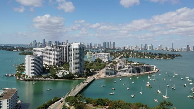 Aerial bridge to Venetian Island on Miami Beach with condo high-rises and sailboat marina and view of Downtown Skyline