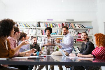 Cheerful coworkers in office during company meeting