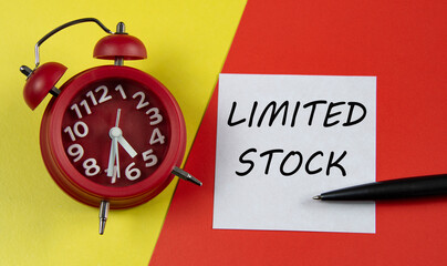 LIMITED STOCK - words on a white sheet on a multi-colored background with an alarm clock and a pen