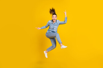 Fototapeta na wymiar Full length body size photo young pretty girl jumping up showing rock heavy metal sign isolated vivid yellow color background