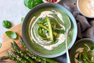 Asparagus and potato cream soup on light background. Top view with copy space. Healthy food.