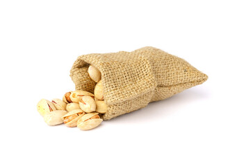 pistachios fall out of the bag, isolated on white background.