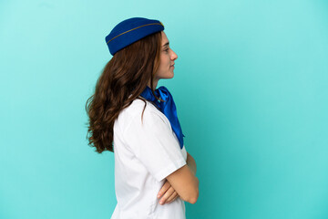 Airplane stewardess woman isolated on blue background in lateral position