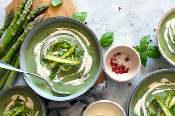 Asparagus and potato cream soup on light background. Top view with copy space. Healthy food.