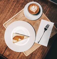 cup of coffee with lemon cake on the wooden table.