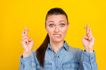 Portrait of nice attractive worried desperate girl praying holding crossed fingers isolated over...