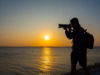 photographer take photo at sunset