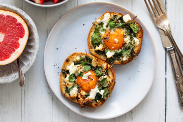 Eggs baked inside brioche bun with watercress and feta