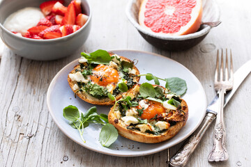 Eggs baked inside brioche bun with watercress and feta