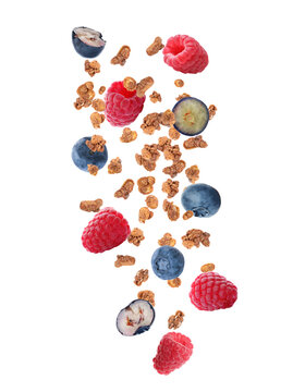 Delicious Granola And Berries Falling On White Background. Healthy Snack