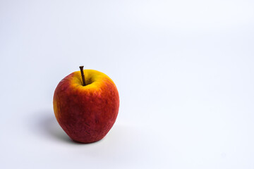 Isolated  of white wallpaper of Spoiled red Apple with wrinkle surface that became yellow.