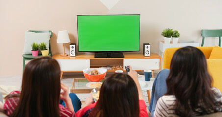 Three females watch green TV