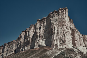 White rock mountain on a background of blue sky