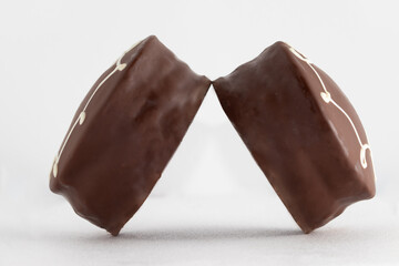 Honey cookies (pão de mel) covered with chocolate on white background.
