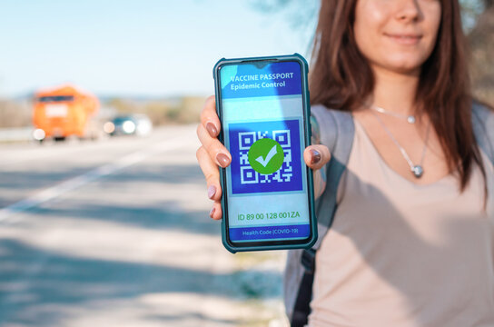 Digital health passport. Woman holding a smartphone with a negative test results for coronavirus. Close up. The concept of a new normal and travel during the pandemic