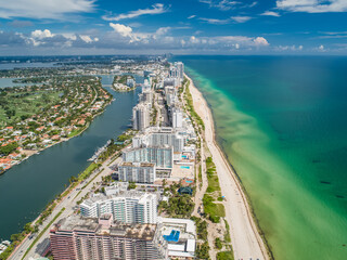 Fototapeta premium Aerial Miami Beach along Collins Avenue mid beach waterway with Yacht Marina and high rise condos